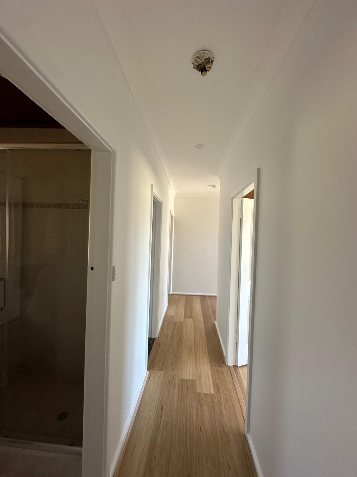 Bright hallway finished in a clean, uniform white