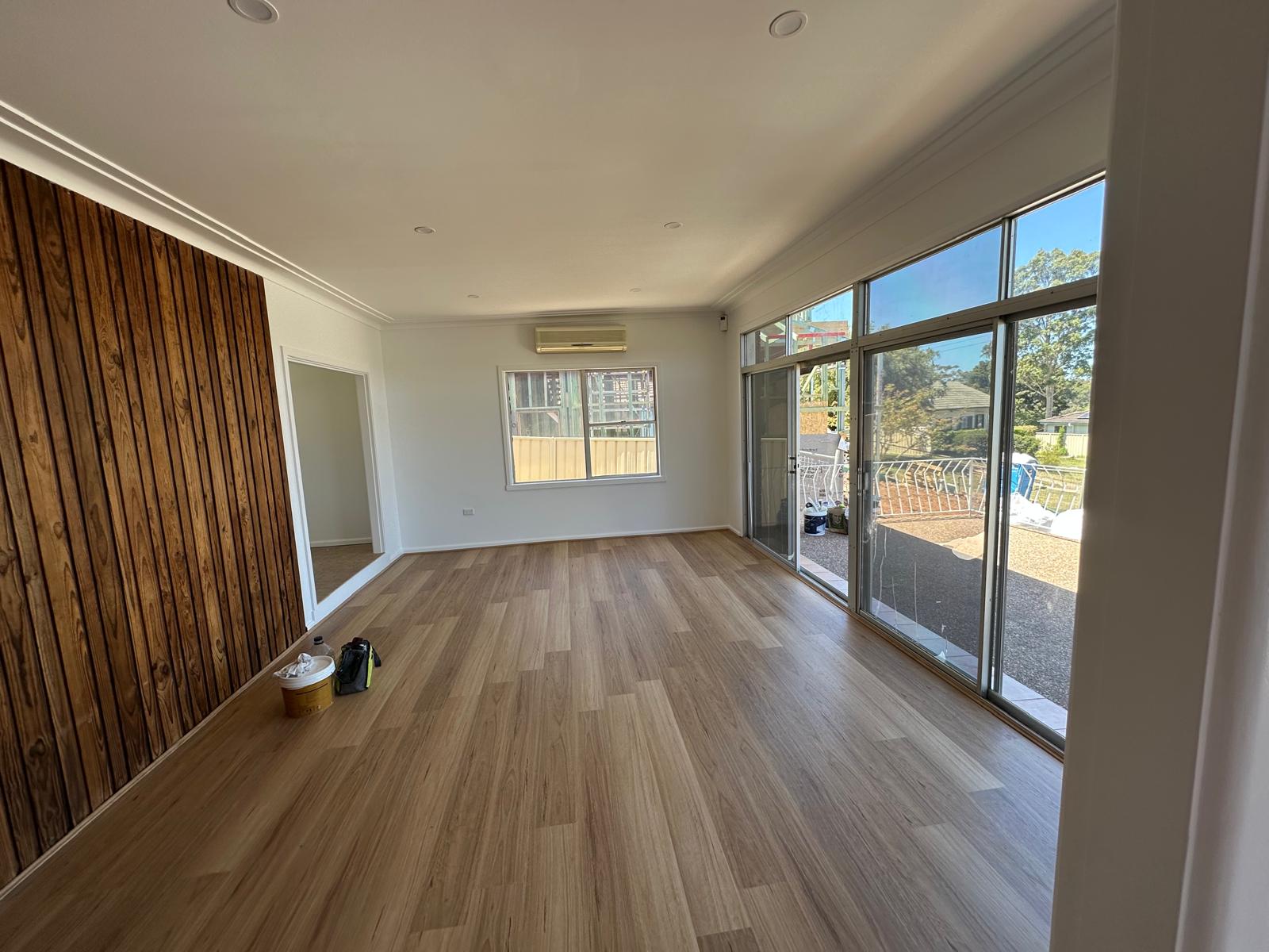 Open living space finished with a striking timber feature wall